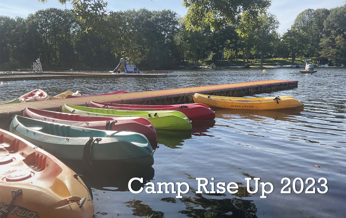 Camp Rise Up 2023, showing canoes at the lake