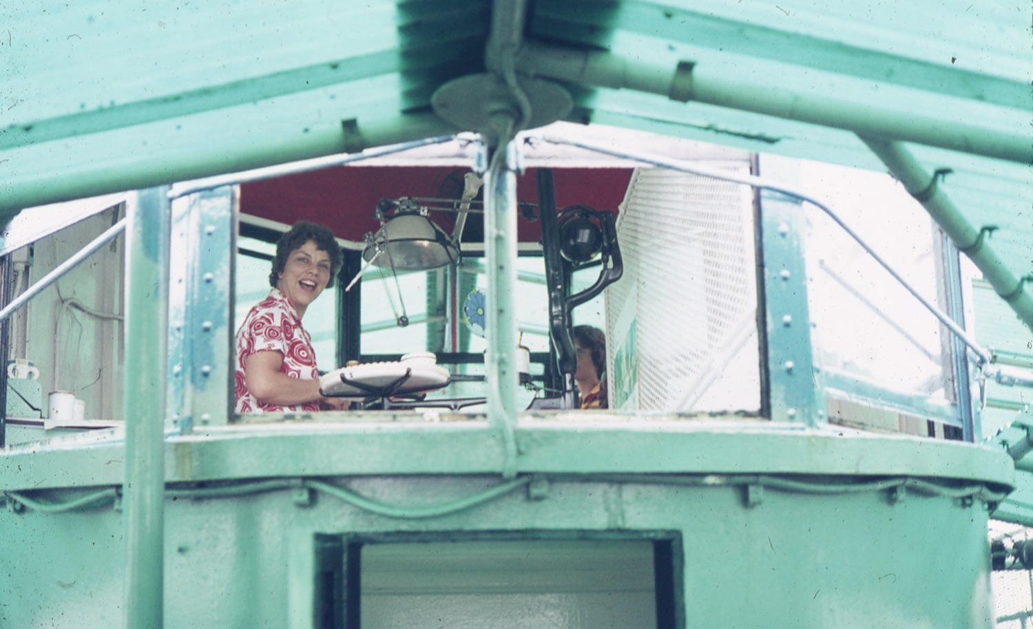 film photo of woman sitting on boat window
